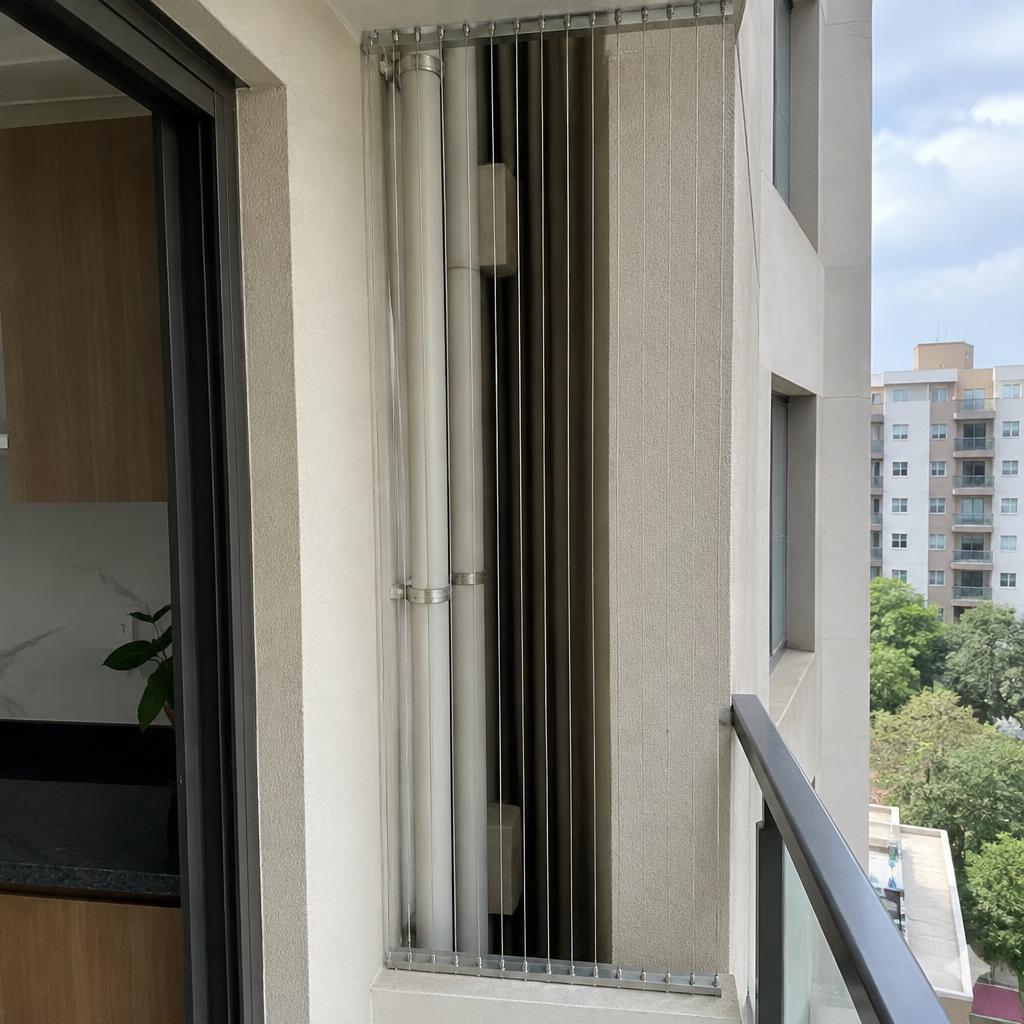 Utility duct opening beside a kitchen balcony fitted with thin stainless steel invisible grill cables